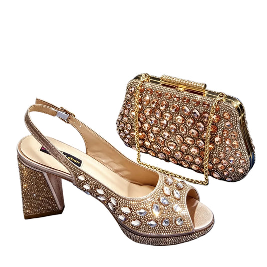 A pair of gold embellished slingback high-heeled sandals displayed with a matching gold rhinestone clutch bag on a draped blue velvet background.